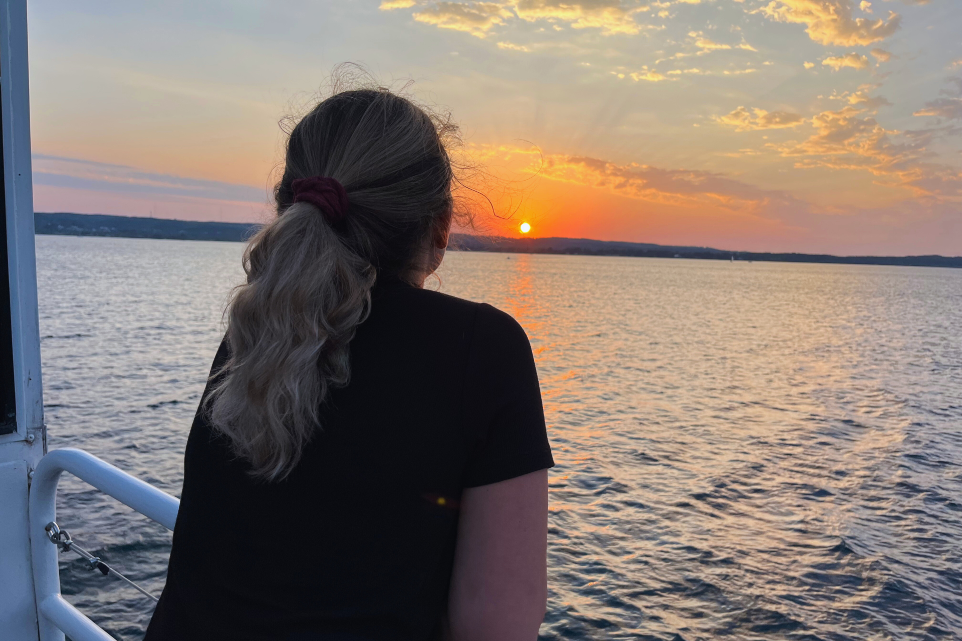 Girl looking at the sunset during traverse city weekend. 