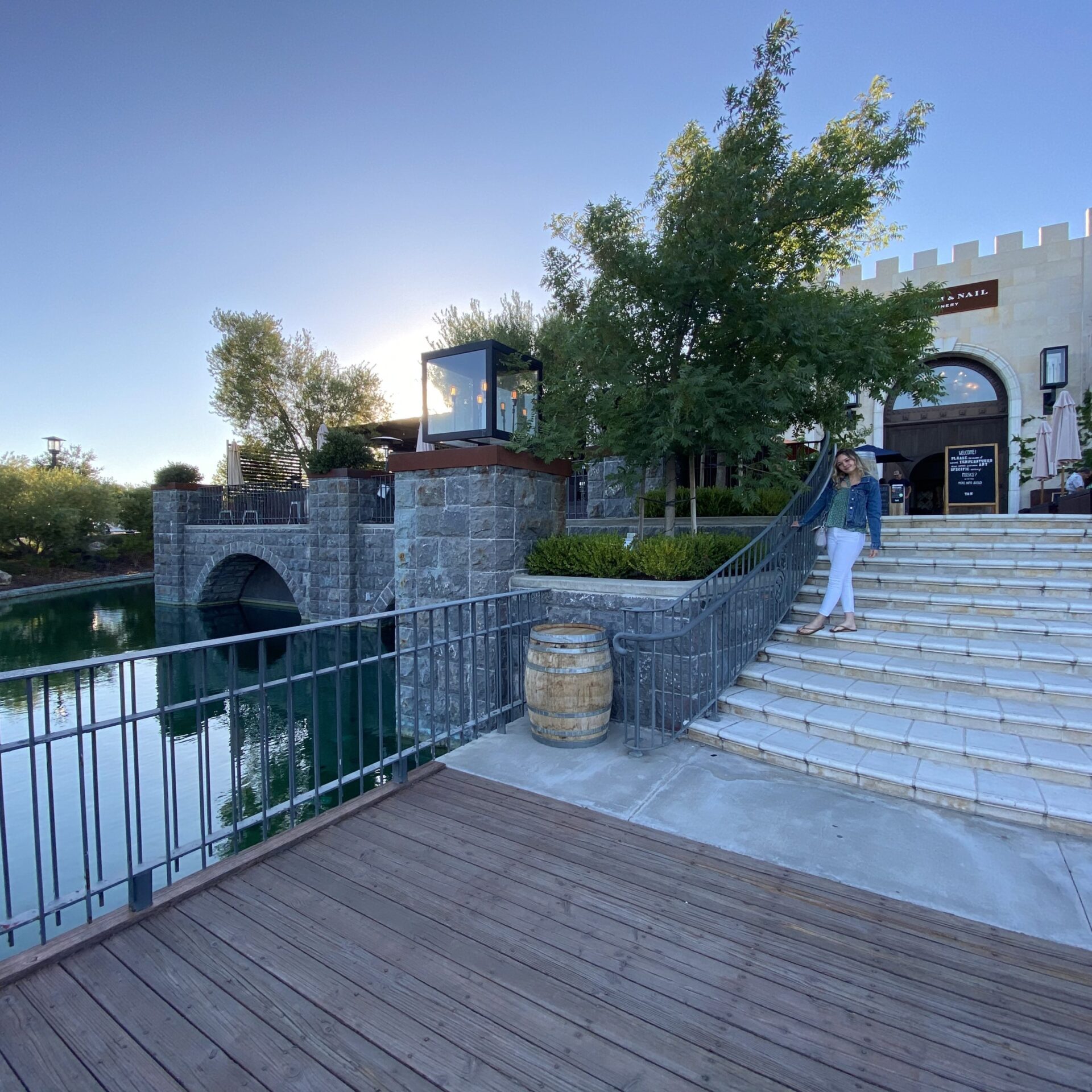 Female standing on the steps at the entrance to a winery in an underrated wine region in California. 