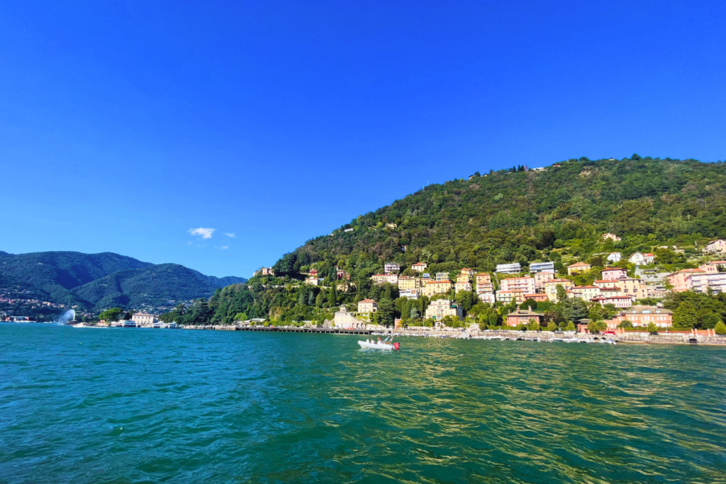 view from a boat on Lake Como, with water and surrounding views